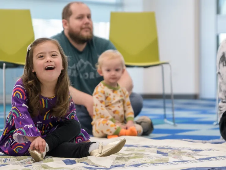 Little girl on floor laughing 