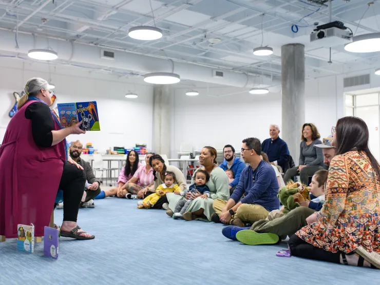 Wide shot of Storytime with many families and babies 