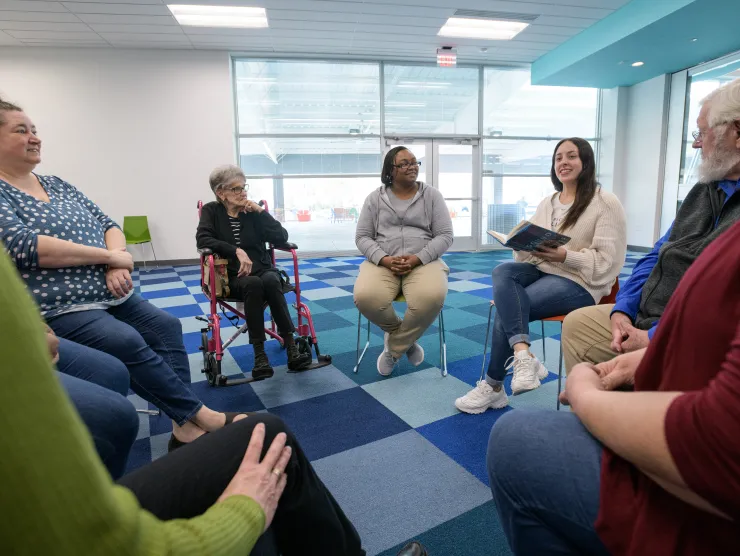 Book club participants sit in a circle