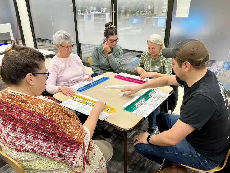 Table of friends learning to play Mah Jongg at the library