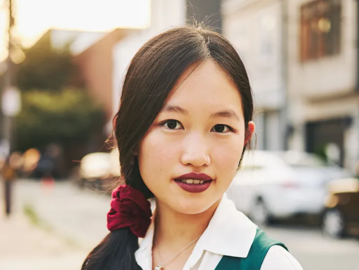 headshot of Rebecca F. Kuang in a green and white shirt