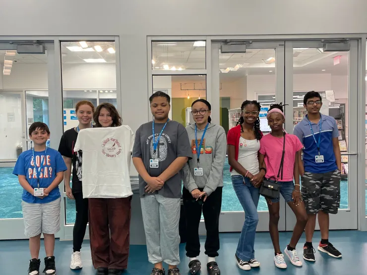 Teens posing for a picture in the library