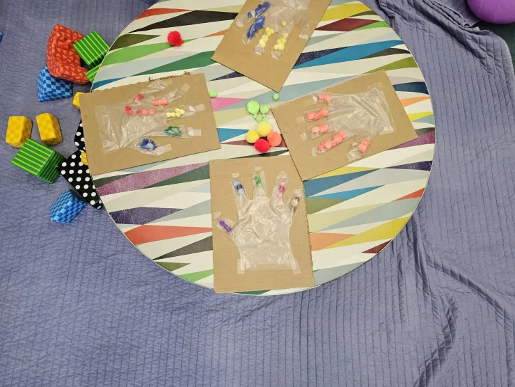 play mat with soft blocks, hand sorters, and bouncy ball.