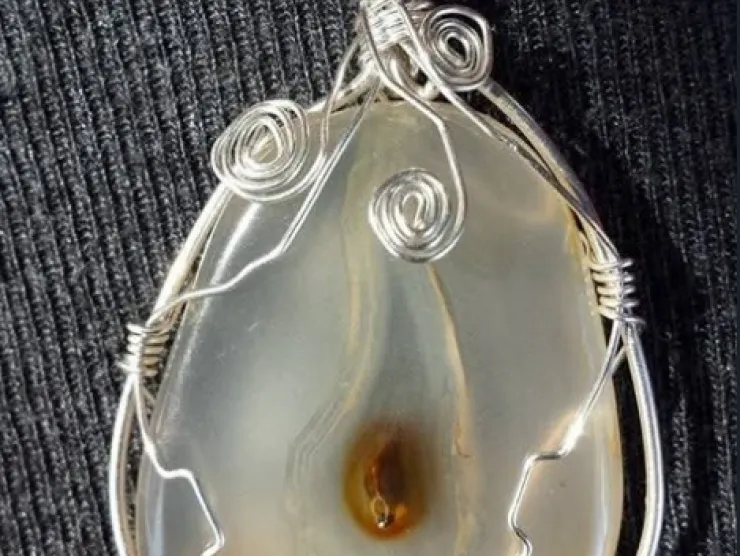 Clear and amber stone wrapped with silver metal wire