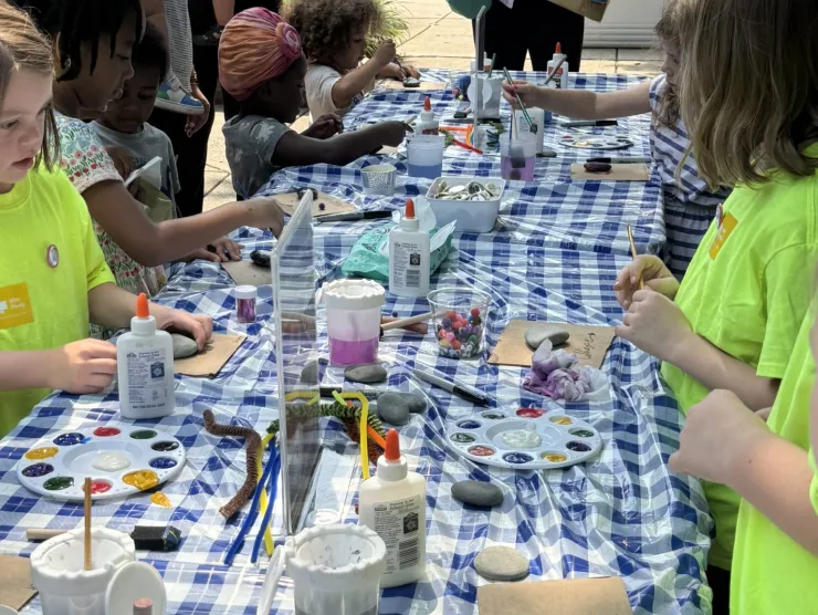 Children making beaded bracelets