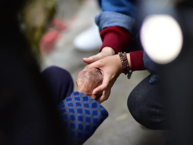 Two individuals holding hands. 