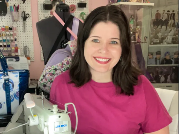 Picture of entrepreneur sitting by a sewing machine