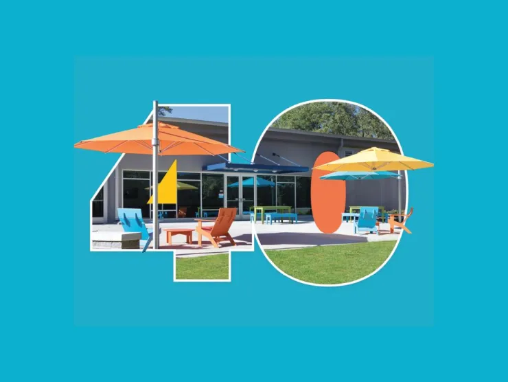 Colorful outdoor patio scene framed inside a large “40,” featuring a modern building, bright umbrellas, and seating on a sunny day against a teal background.