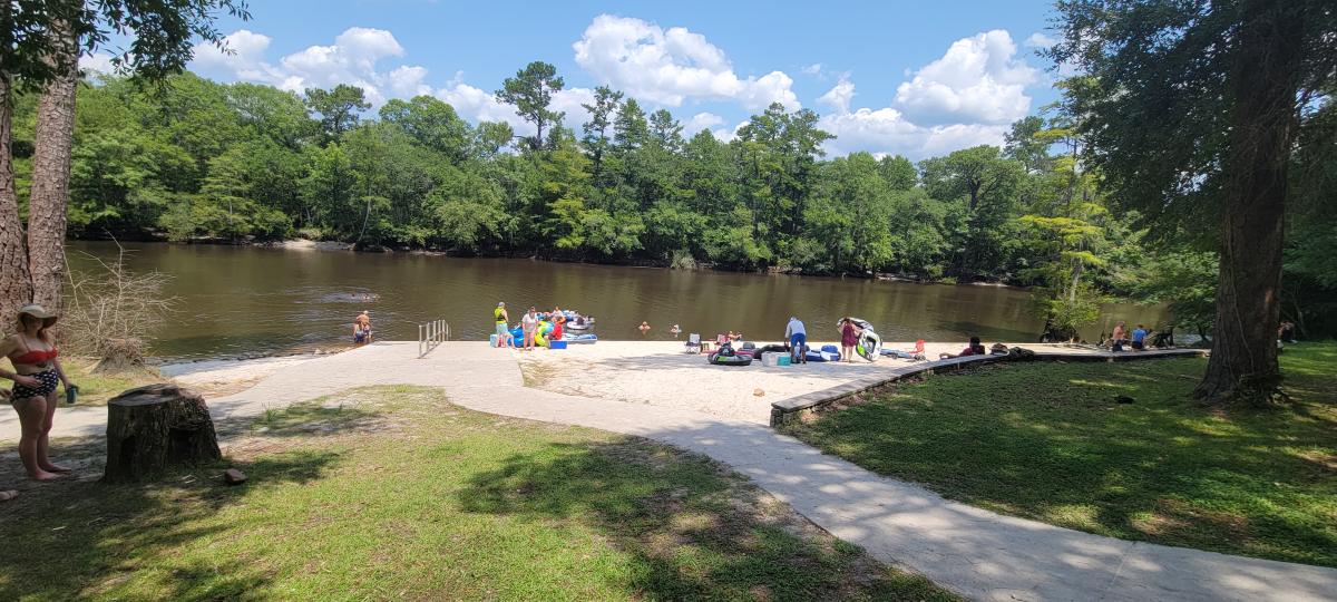 people with inner tubes near river