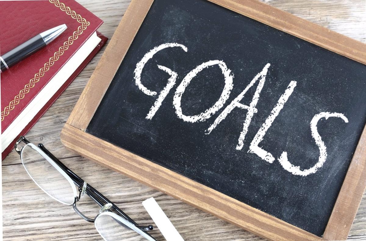 A chalkboard with goals written on it.