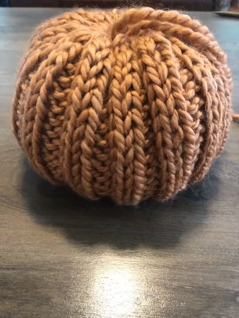 an almost finished 2x2 ribbed knit pumpkin