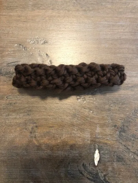 Dark brown knitted stem for your pumpkin, ready to attach