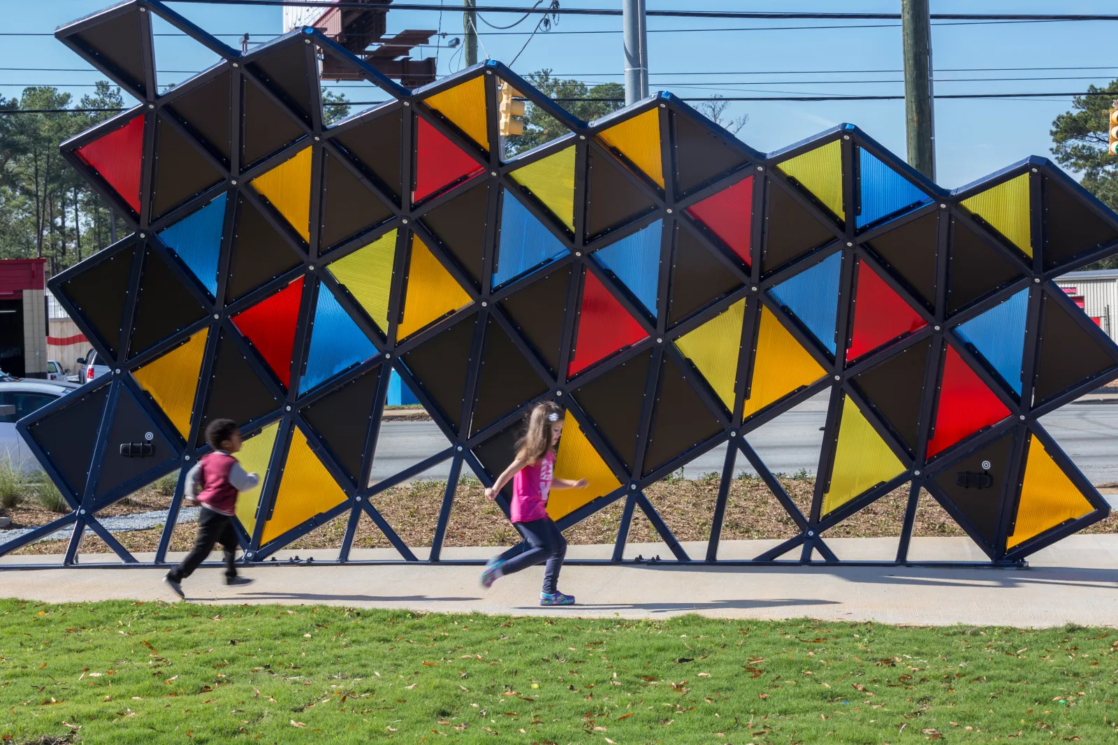 Children play in front of the public art at Richland Library St. Andrews