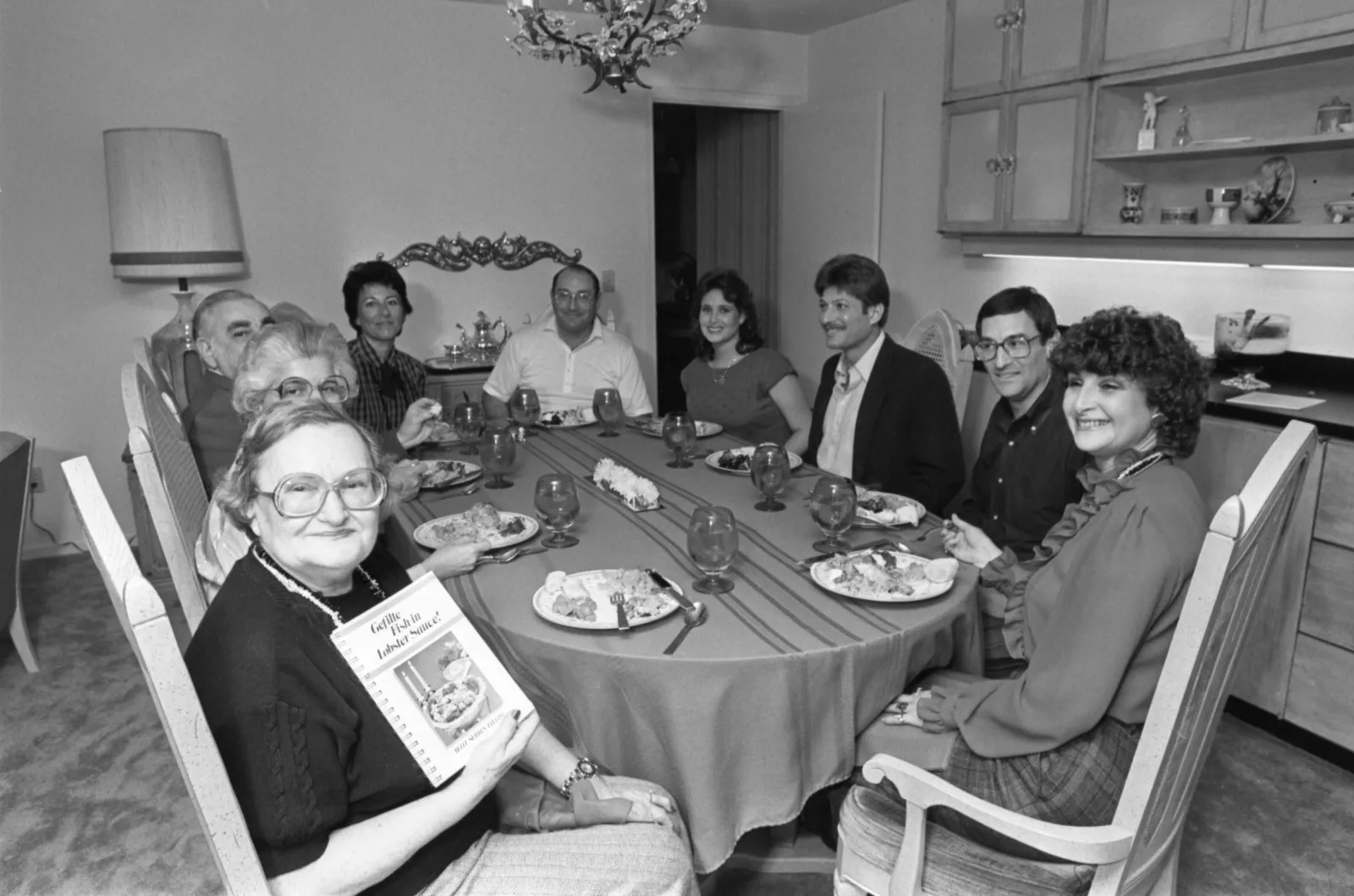 Image of Belle Serbin Fields and family with cookbook.
