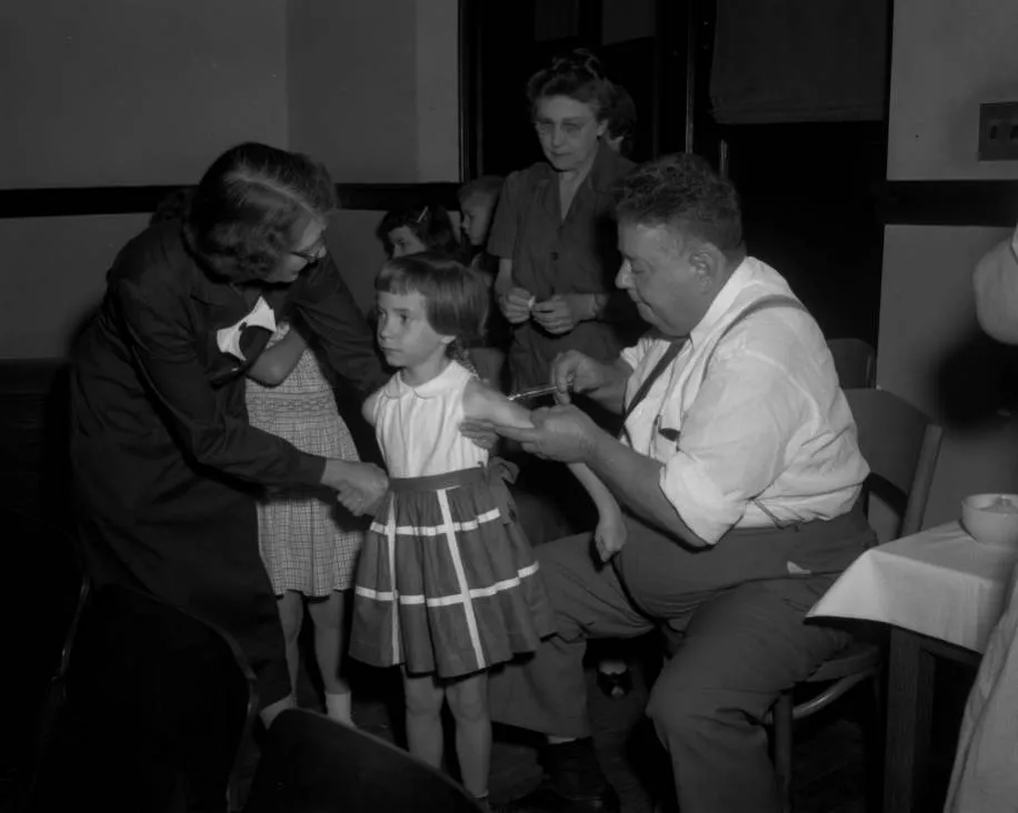 Image of a child getting the Polio vaccine in 1955.