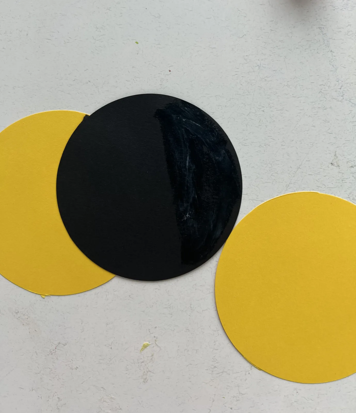 Two yellow circles and one black circle for bee body