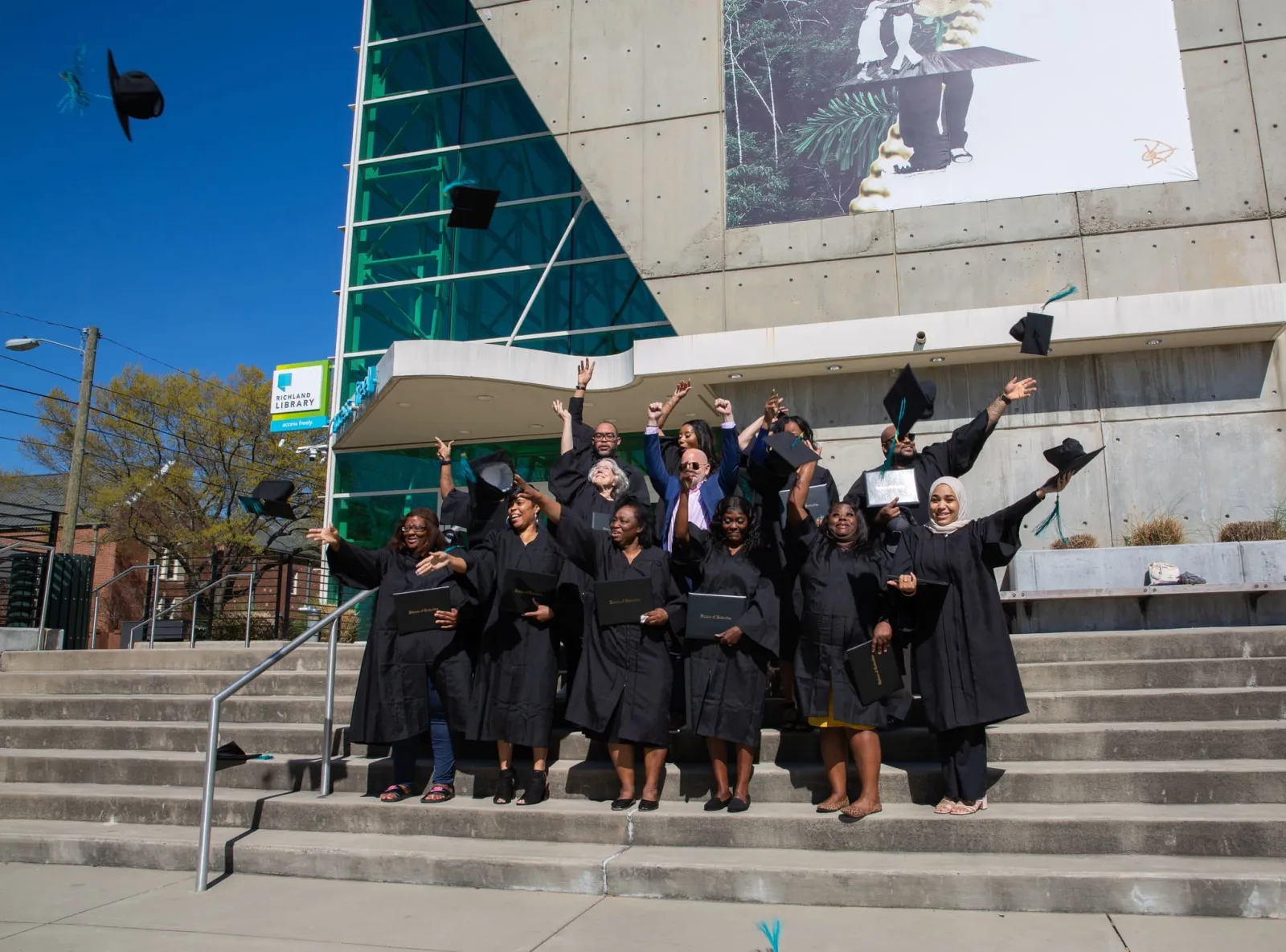 graduating class throwing their caps