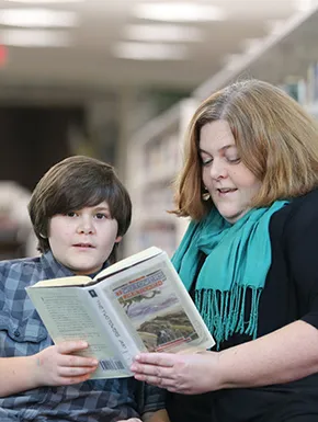 Mother and son reading chapter book together