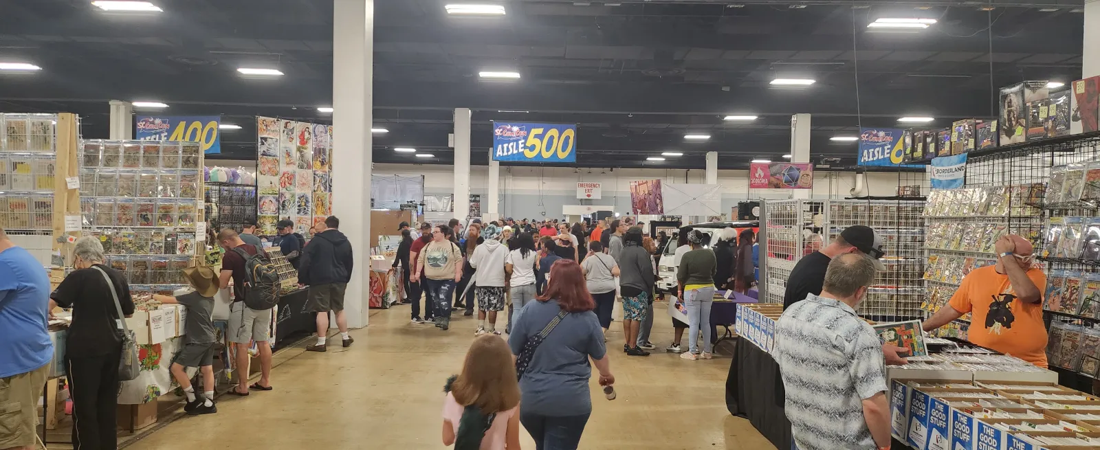 crowd of people looking at comics