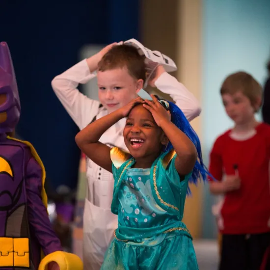children dance wearing costumes
