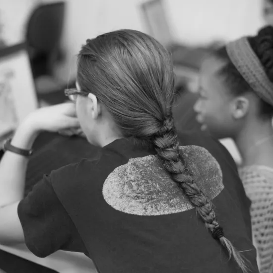 Teen girl getting assistance on laptop