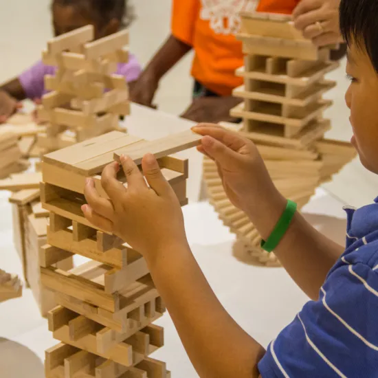 Boy building with keva planks.