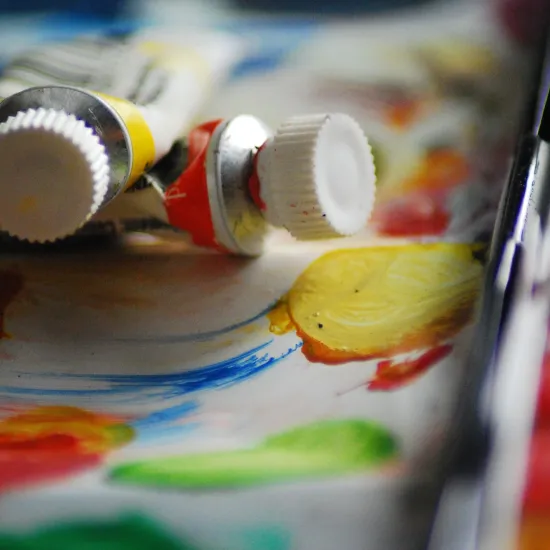 paper with paint colors and tubes of paint