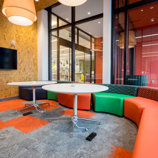 Comfortable seating with couches, chairs and a monitor on the wall