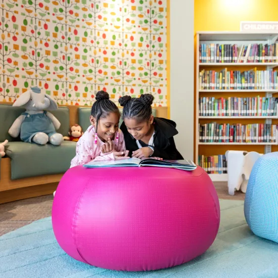 Two little girls reading at Edgewood