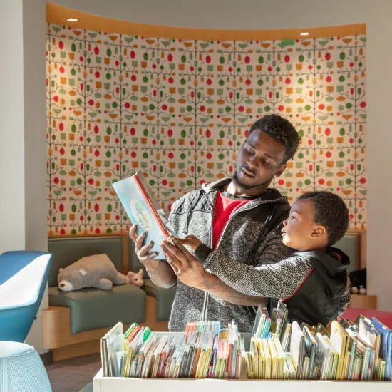 Father and son pick out books at Edgewood