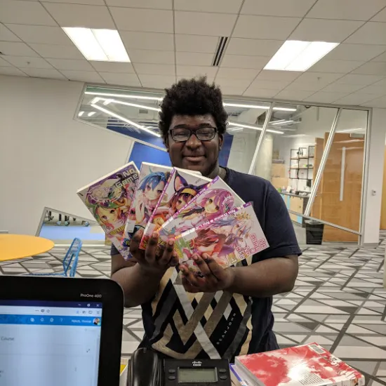 Teen shows off a collection of Manga at Richland Library