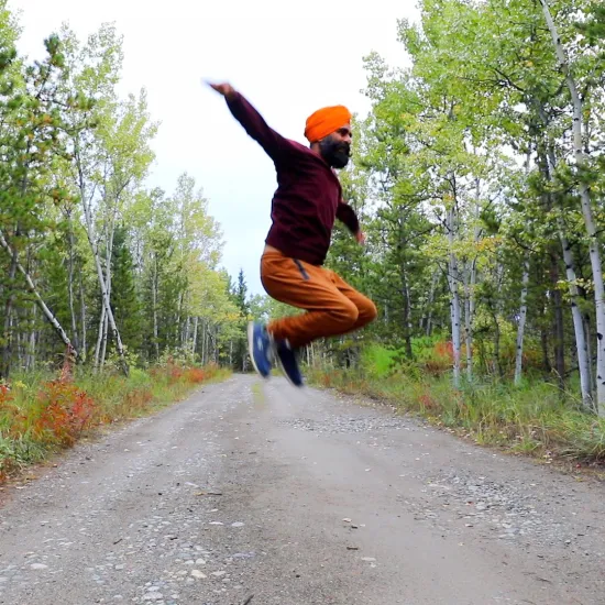 Picture of Gurdeep Pandher | Photo of a man wearing a turban leaping into the air 