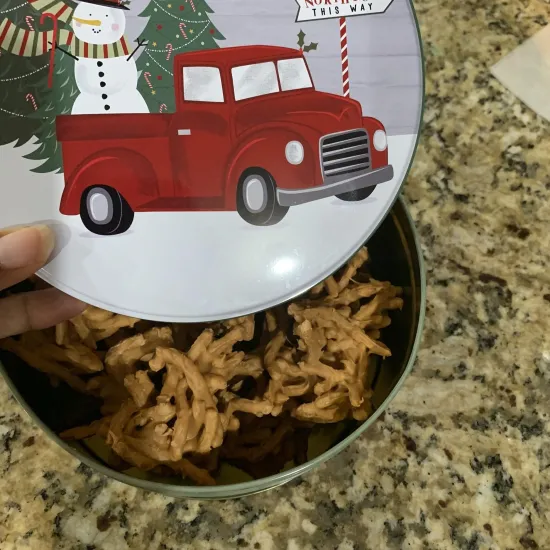 Tin of haystack candies with winter scene on the lid.