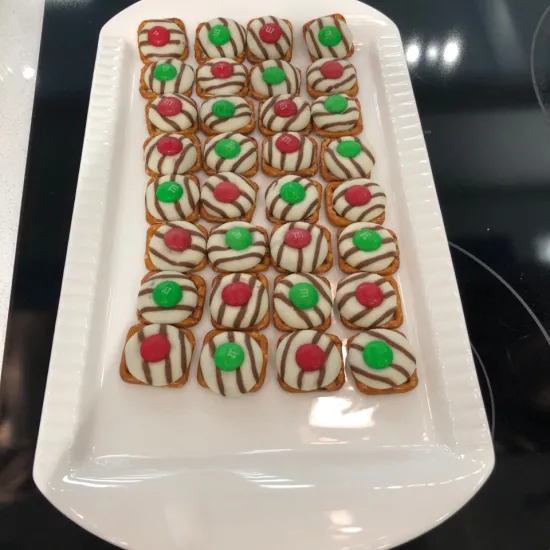 Pretzel hugs candies on a white ceramic tray.