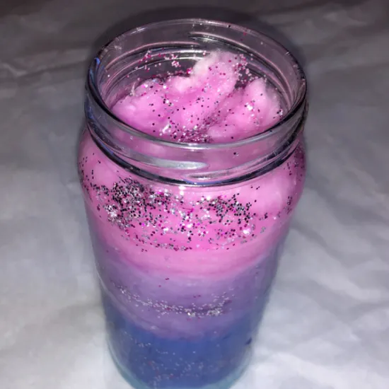 Mason Jar with different color cotton (pink, purple, periwinkle, and blue) and glitter (silver and purple) inside