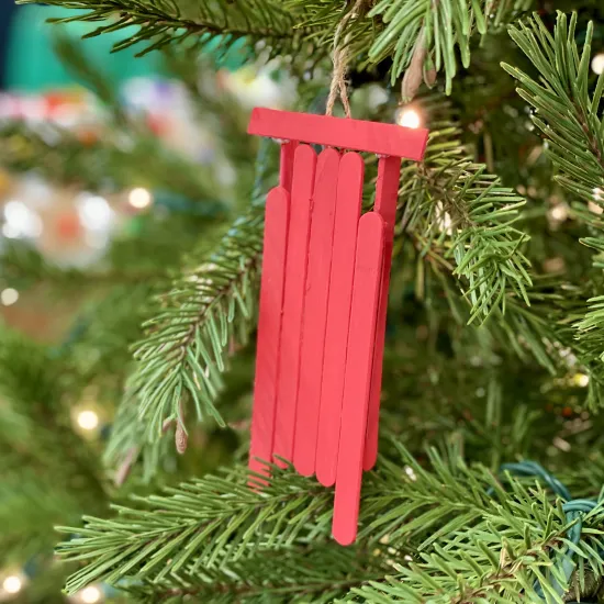 red sled made of popsicle sticks