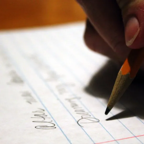 Hand writing on paper with a pencil