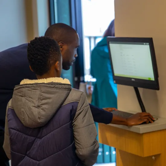 Man and boy searching a computer