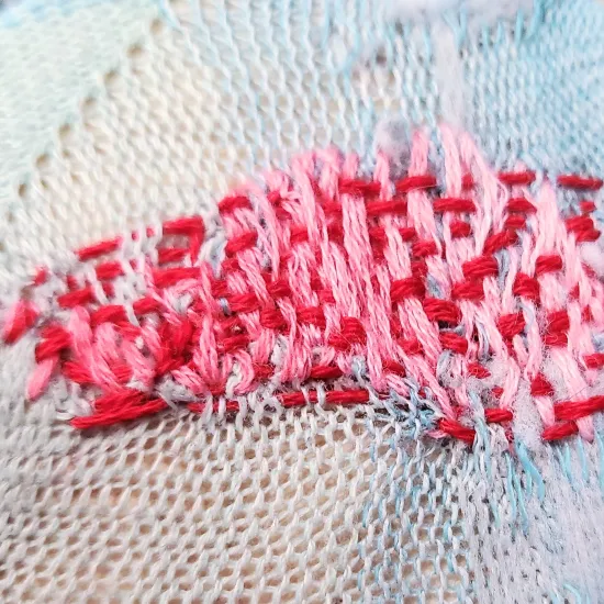 Pink and Red hand sewn darn weave on thin heel of sock