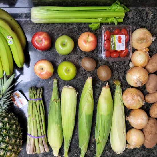 rows of banana pineapple corn apples celery tomatoes onions and potatoes